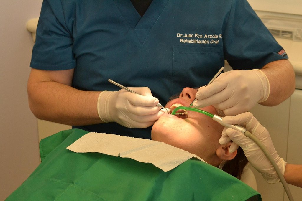 Dentist operating on a female patient in a modern dental clinic